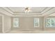 Spacious bedroom with tray ceiling, ceiling fan, two windows offering natural light, and neutral walls at 4963 Kingsbridge Ct, Powder Springs, GA 30127