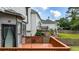 Exterior view of a multi-level deck and lush green yard with flowering plants at 4963 Kingsbridge Ct, Powder Springs, GA 30127