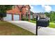 Well-maintained driveway leading to a charming brick home with a manicured front yard at 4963 Kingsbridge Ct, Powder Springs, GA 30127