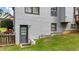 Exterior door view of home featuring gray siding, green grass and landscaping at 4963 Kingsbridge Ct, Powder Springs, GA 30127