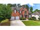 Traditional brick home with a manicured lawn and lush landscaping in a desirable neighborhood at 4963 Kingsbridge Ct, Powder Springs, GA 30127