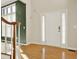Bright foyer featuring hardwood floors, neutral walls, and a white front door with sidelights at 4963 Kingsbridge Ct, Powder Springs, GA 30127