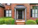 Close-up of the home's front entrance, showcasing a welcoming door and manicured bushes at 4963 Kingsbridge Ct, Powder Springs, GA 30127