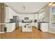 Bright kitchen features white cabinets, stainless steel appliances, and a functional center island at 4963 Kingsbridge Ct, Powder Springs, GA 30127