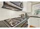 Stainless steel gas cooktop and under-cabinet vent hood at 4963 Kingsbridge Ct, Powder Springs, GA 30127
