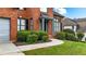 Lush bushes and landscaping around the front entrance of a well-maintained brick home at 4963 Kingsbridge Ct, Powder Springs, GA 30127