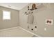 Functional laundry room with shelving and utility connections for laundry appliances, plus a window at 4963 Kingsbridge Ct, Powder Springs, GA 30127