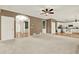 Open-concept living room with hardwood floors and neutral walls, with view to the kitchen and foyer at 4963 Kingsbridge Ct, Powder Springs, GA 30127