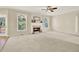 Bright living room featuring a fireplace, large windows, and neutral colored walls at 4963 Kingsbridge Ct, Powder Springs, GA 30127