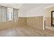 Charming living room with wood-look tile, paneled walls, and bright natural light at 4963 Kingsbridge Ct, Powder Springs, GA 30127