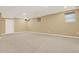 Spacious carpeted basement living area featuring recessed lighting and multiple windows at 4963 Kingsbridge Ct, Powder Springs, GA 30127