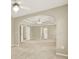 Spacious main bedroom featuring tray ceilings, neutral paint, and an arched entry into attached room at 4963 Kingsbridge Ct, Powder Springs, GA 30127