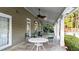 Covered patio features ceiling fans, tables, and comfortable seating at 4963 Kingsbridge Ct, Powder Springs, GA 30127