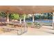 Community picnic shelter with picnic tables and tennis court in background at 4963 Kingsbridge Ct, Powder Springs, GA 30127