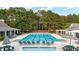 Community pool is surrounded by ample seating and lush landscaping at 4963 Kingsbridge Ct, Powder Springs, GA 30127