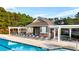 Relaxing pool-side lounge area with shaded picnic tables and ample seating at 4963 Kingsbridge Ct, Powder Springs, GA 30127