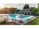 Community pool features a covered patio, lush landscaping, and plenty of seating at 4963 Kingsbridge Ct, Powder Springs, GA 30127