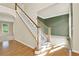 Inviting foyer with a staircase and hardwood flooring, leading to rooms with neutral color palettes and plenty of natural light at 4963 Kingsbridge Ct, Powder Springs, GA 30127
