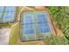 The two tennis courts are newly resurfaced with green surfaces, black nets and black fencing at 4963 Kingsbridge Ct, Powder Springs, GA 30127