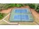 Aerial view of the community's fenced in tennis courts, nets, and gated sidewalks at 4963 Kingsbridge Ct, Powder Springs, GA 30127