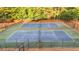 Aerial view of side-by-side tennis courts with newly resurfaced blue and green surfaces at 4963 Kingsbridge Ct, Powder Springs, GA 30127
