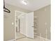 Organized walk-in closet with built-in shelving for storage and a view into connecting room at 4963 Kingsbridge Ct, Powder Springs, GA 30127