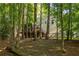 A backyard view highlighting the deck, the wooded setting and the natural surroundings at 5999 Brookside Se Ln, Mableton, GA 30126