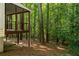 View of the home's screened porch and wooded backyard at 5999 Brookside Se Ln, Mableton, GA 30126