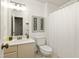 Neutral-toned bathroom with a vanity, mirror, toilet, decorative art, and a shower and tub combo at 5999 Brookside Se Ln, Mableton, GA 30126