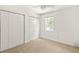 Carpeted bedroom showcasing two closets and a window letting in natural light at 5999 Brookside Se Ln, Mableton, GA 30126