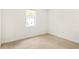 Empty bedroom with neutral carpeting and white walls and a window at 5999 Brookside Se Ln, Mableton, GA 30126