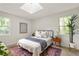 Cozy bedroom with natural light, neutral walls, an area rug, and a metal frame bed at 5999 Brookside Se Ln, Mableton, GA 30126