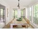 Dining room featuring large windows, a stylish light fixture, and seating for six people at 5999 Brookside Se Ln, Mableton, GA 30126