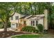 Two-story home boasts a lush lawn and mature trees providing shade and privacy at 5999 Brookside Se Ln, Mableton, GA 30126