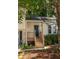 The front porch welcomes visitors to this charming home nestled among mature trees at 5999 Brookside Se Ln, Mableton, GA 30126