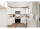Modern kitchen features sleek white cabinetry, stainless steel appliances, and hardwood floors at 5999 Brookside Se Ln, Mableton, GA 30126