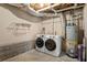 Functional laundry area with modern washer/dryer, water heater, and storage at 5999 Brookside Se Ln, Mableton, GA 30126