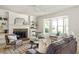 Bright and airy living room with fireplace, built-in shelving, and a large window for natural light at 5999 Brookside Se Ln, Mableton, GA 30126