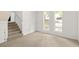 Sunlit carpeted room with large windows and stairway at 5999 Brookside Se Ln, Mableton, GA 30126