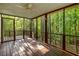 Back porch featuring wood floors and walls, and protection from the elements from the screened enclosure at 5999 Brookside Se Ln, Mableton, GA 30126