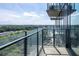 Condo balcony featuring glass railings with a view of the surrounding trees at 788 W Marietta Nw St # 311, Atlanta, GA 30318
