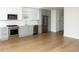 Modern kitchen featuring stainless steel appliances, white cabinets, and hardwood floors at 788 W Marietta Nw St # 311, Atlanta, GA 30318