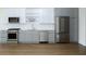 Modern kitchen featuring stainless steel appliances, white cabinets, and hardwood floors at 788 W Marietta Nw St # 311, Atlanta, GA 30318