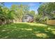 Backyard featuring a well-maintained lawn, wood fencing, and a cozy home with a deck nestled among green trees at 1364 Westboro Sw Dr, Atlanta, GA 30310