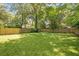 Large grassy backyard enclosed by a wood fence, offering privacy and plenty of space for outdoor activities at 1364 Westboro Sw Dr, Atlanta, GA 30310