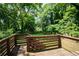 Spacious backyard featuring a wooden deck with lush greenery in the surrounding trees at 1364 Westboro Sw Dr, Atlanta, GA 30310