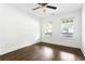 Inviting bedroom featuring hardwood floors, two windows for natural light, and a ceiling fan at 1364 Westboro Sw Dr, Atlanta, GA 30310