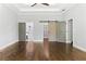 Spacious bedroom with hardwood floors, a tray ceiling, and doors to the bathroom and walk-in closet at 1364 Westboro Sw Dr, Atlanta, GA 30310