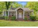 Charming brick home with a cozy front porch, lush lawn, and mature trees in a quiet neighborhood at 1364 Westboro Sw Dr, Atlanta, GA 30310