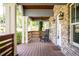 Charming covered front porch with brick support columns, wooden ceiling, a rocking chair, and hanging lanterns at 1364 Westboro Sw Dr, Atlanta, GA 30310